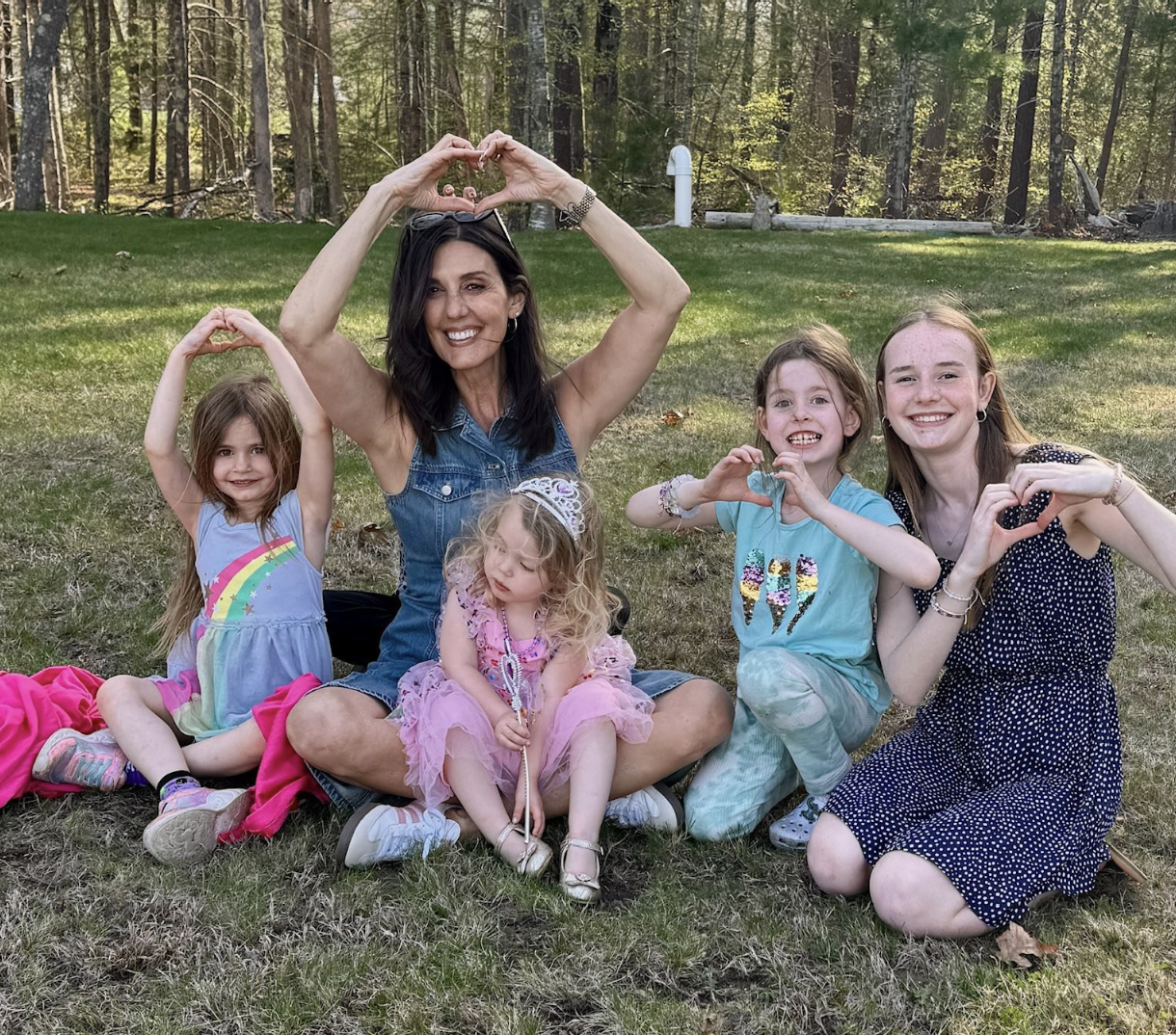 Summer campers with Maria and heart hands